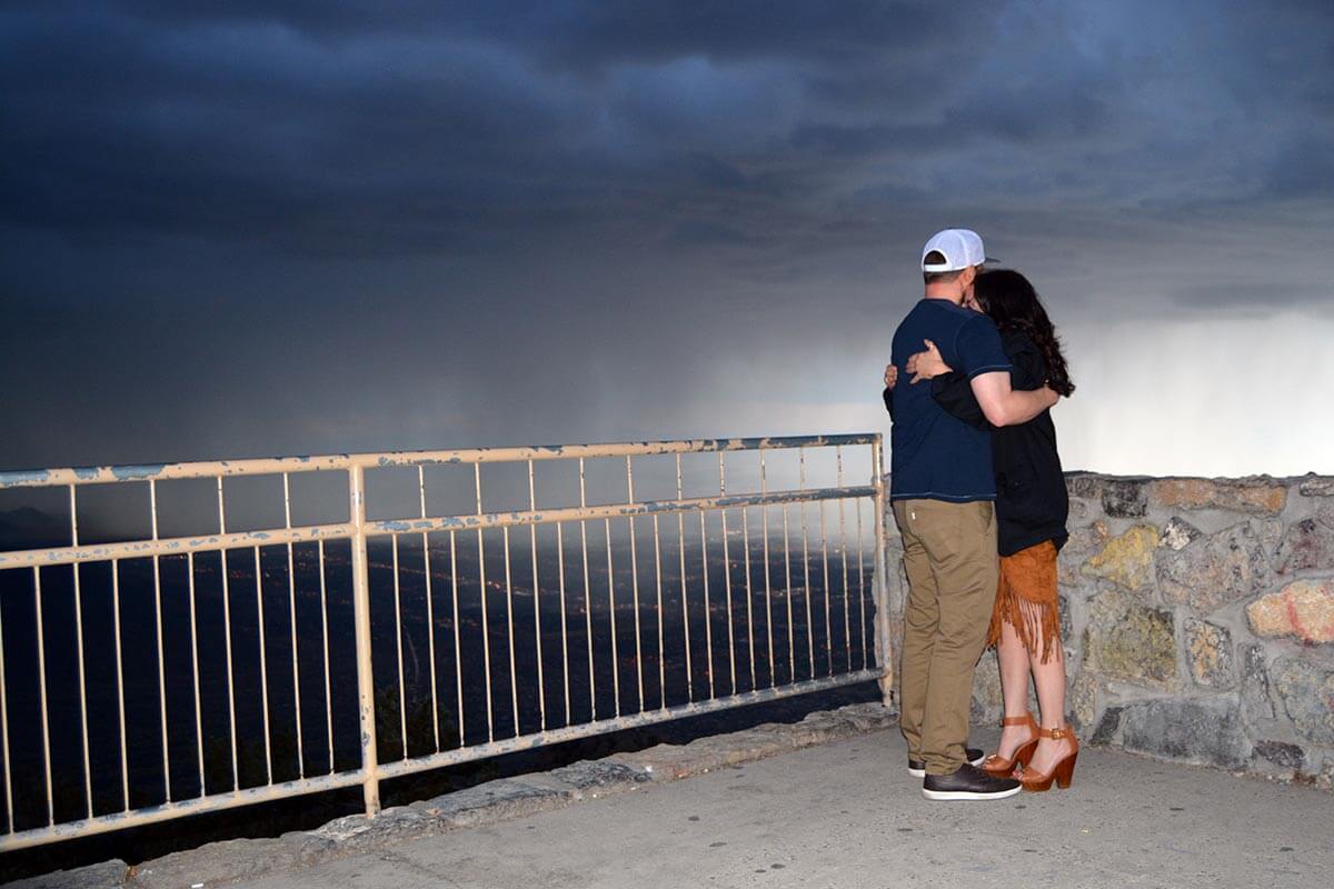 a couple hugging on a stormy evening on the Sandia Mountains in Albuquerque
